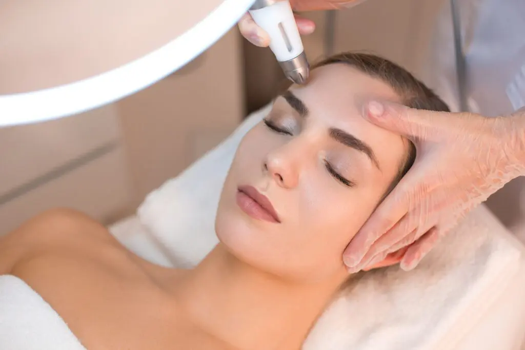 Woman receiving laser skin resurfacing treatment.