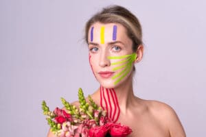 Woman with face paint and bouquet of flowers
