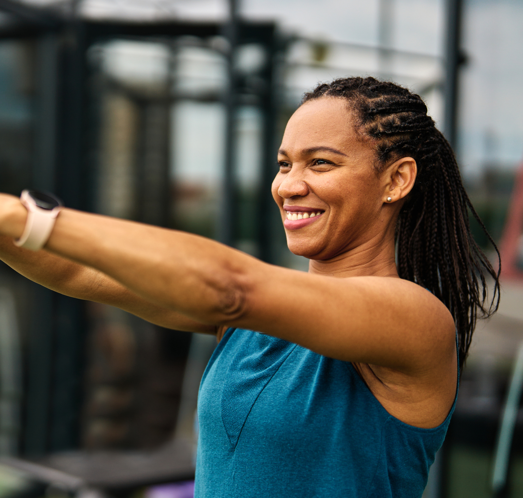 Portrait of a young black woman  exercising in a gym, lifting weights, kettlebell equipment, healthy lifestyle and strength exercise at fitness club concepts